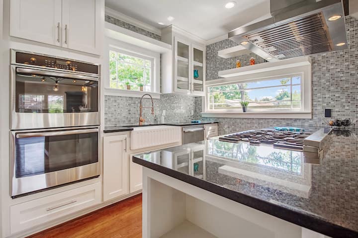 An image of a modern kitchen with sleek appliances, featuring a gas stove, refrigerator, and built-in microwave in Vienna